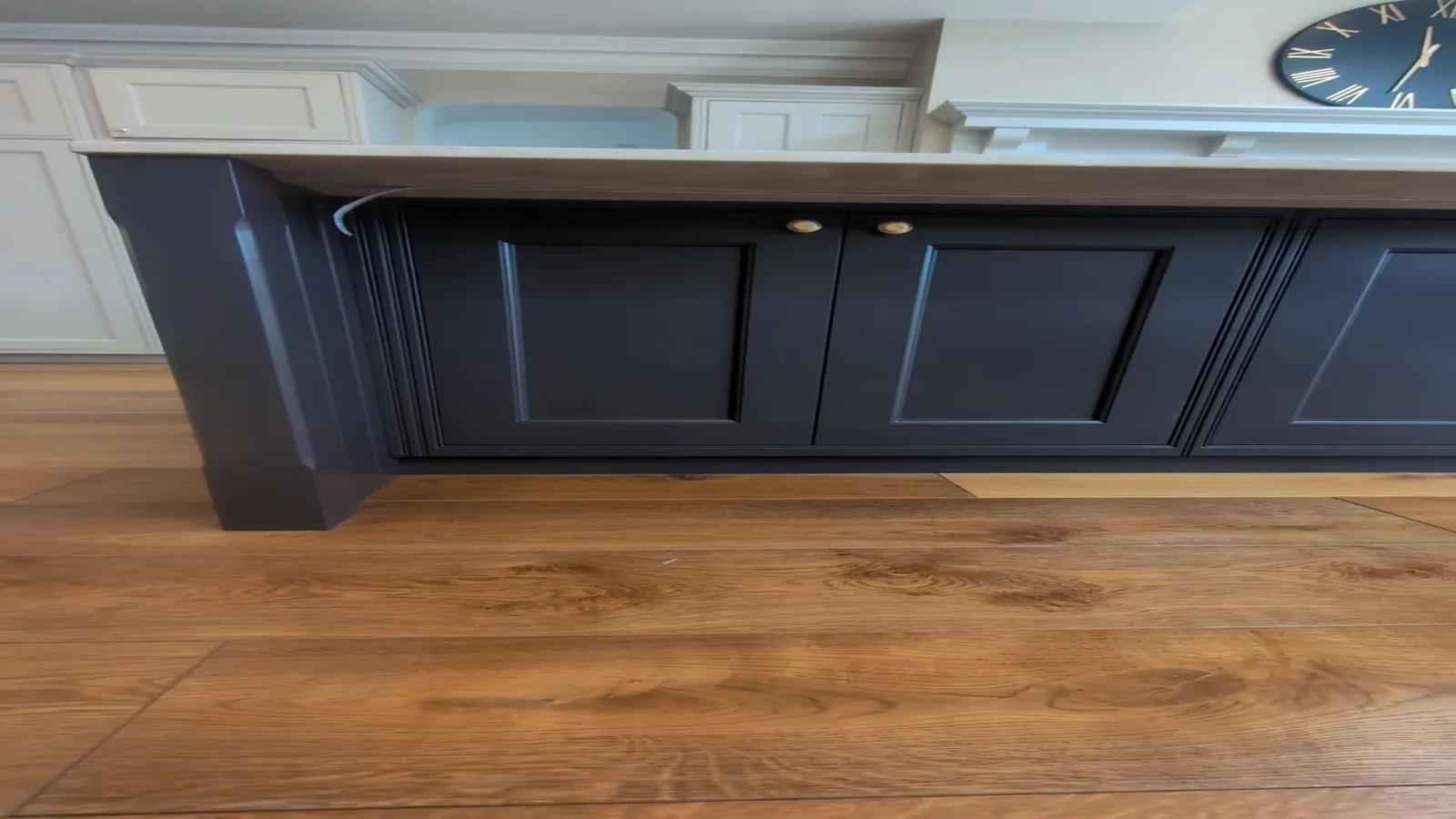 The same kitchen island in its original dark navy finish before respraying